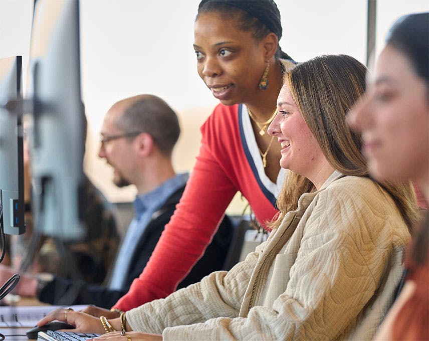 Women working together at a computer